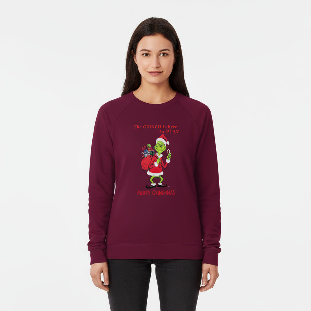 Woman wearing a burgundy sweatshirt with a Christmas-themed design.